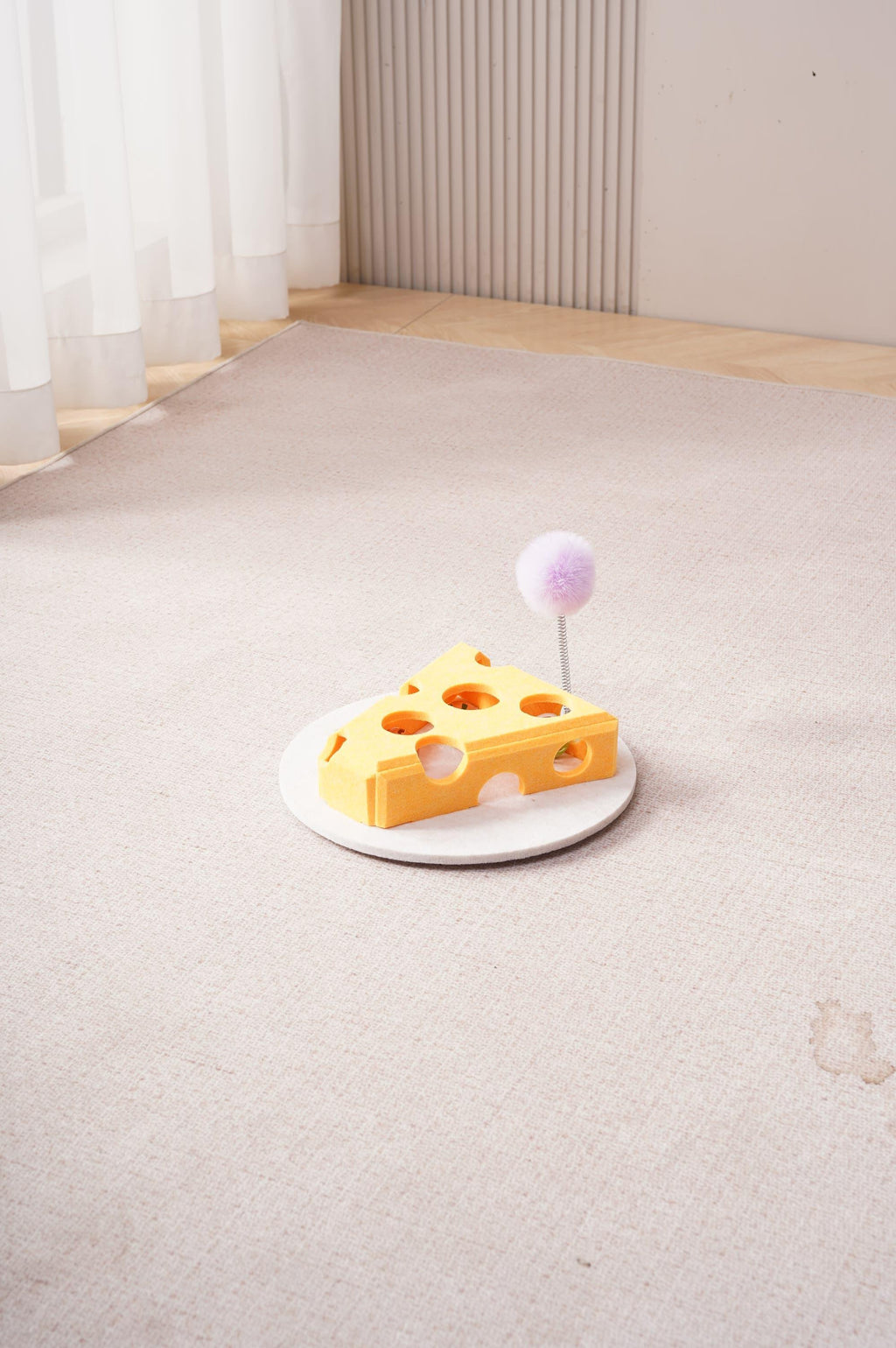 Yellow cheese shaped interactive cat puzzle box with treat holes and spring plush teaser toy
