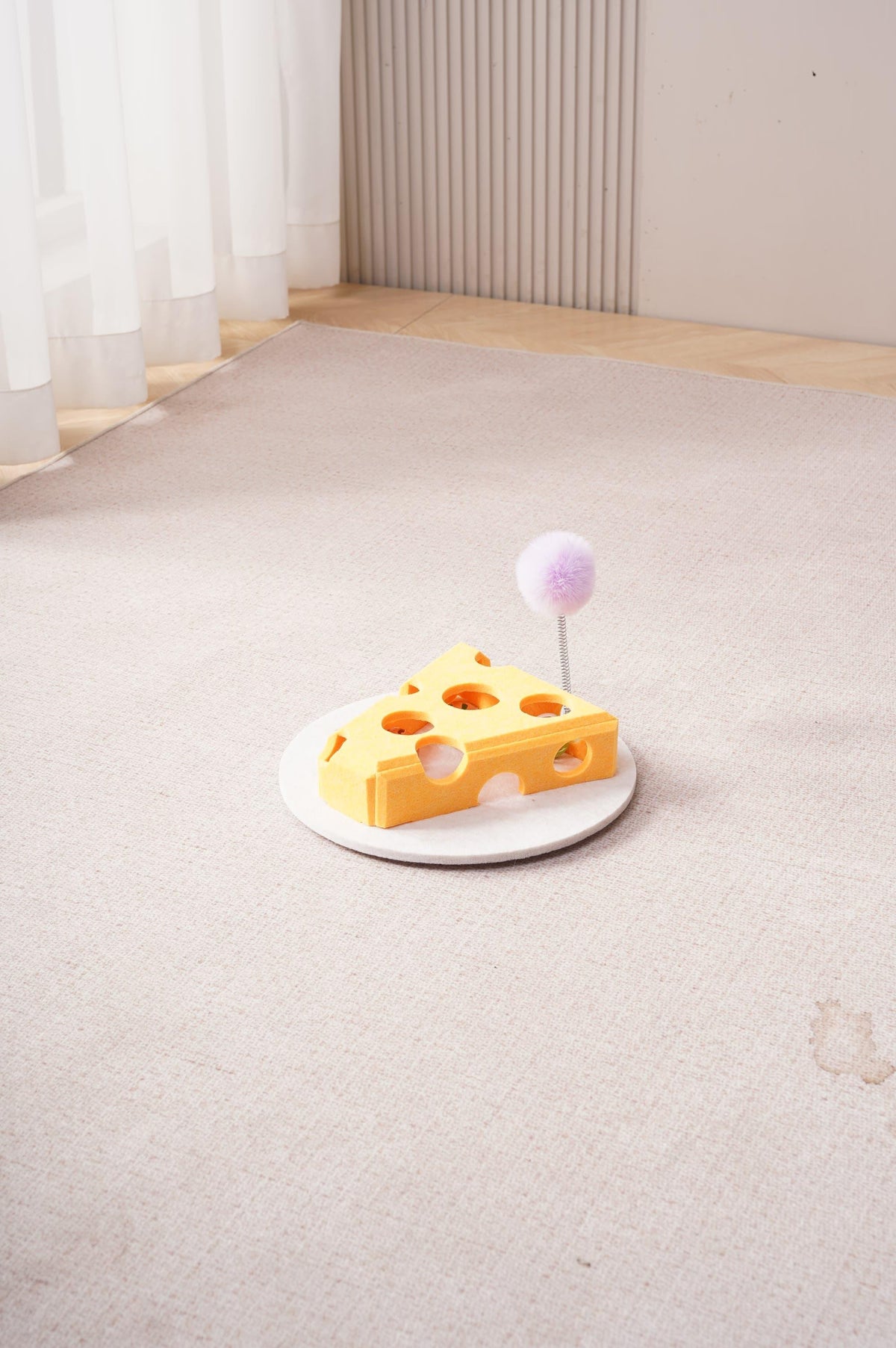 Yellow cheese shaped interactive cat puzzle box with treat holes and spring plush teaser toy